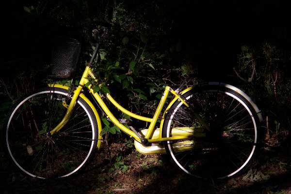 The yellow bicycle without the saddle